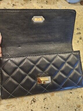 Michael Kors Black Quilted Leather Turn-Lock Wallet With Silver Hardware.
